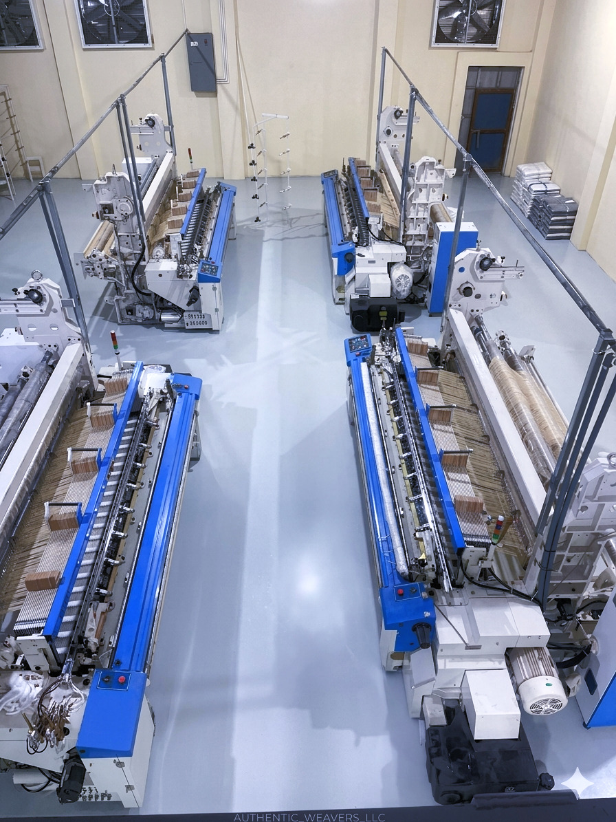 Modern blue weaving looms arranged inside the Son Ha Textile factory