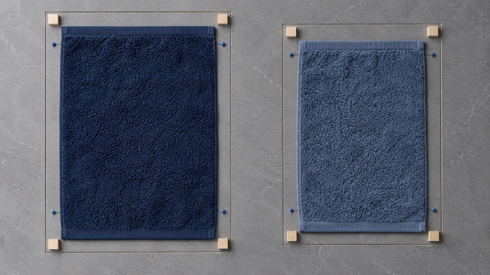 Blue towel samples aligned on a measurement surface before and after laundering
